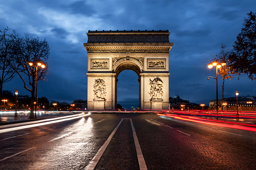 Arc de Triomphe and Place Charles de Gaulle / place de l'Etoile, in Paris, by night, long exposure. Paris in France. December 14, 2020.