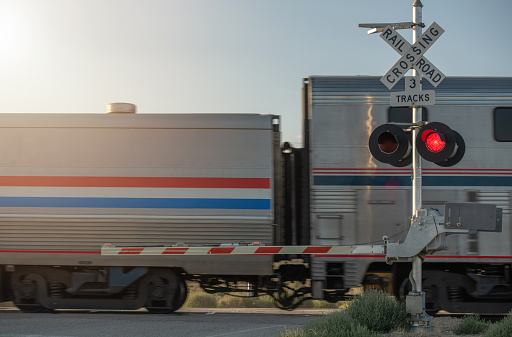 Crossing Crossbuck Sign. Closed Utah Railroad Crossing and Passing Train. Rail Theme.