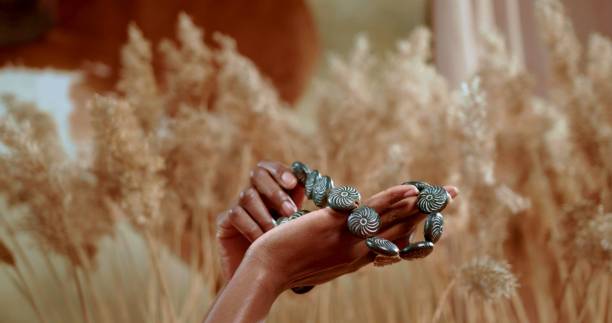 istock African hands which are holding a traditional necklace 1341756618