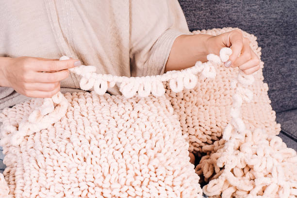 istock Knits made from thick soft yarn. Soft knitted cushions made of thick yarn. 1341759715