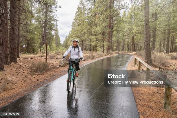 Active Mixed Race Senior Woman On Relaxing Bike Ride Stock Photo - Download Image Now
