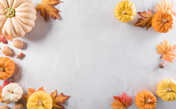 istock Autumn composition. Pumpkin, autumn leaves and apple on stone background. Flat lay, top view with copy space. 1341761006