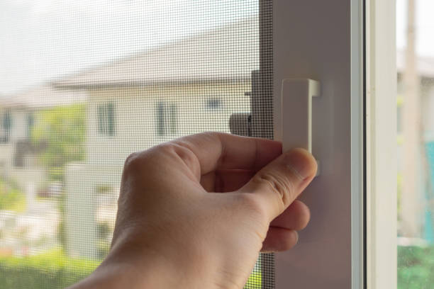 istock Hand hold mosquito net wire screen handle on house window 1341761218