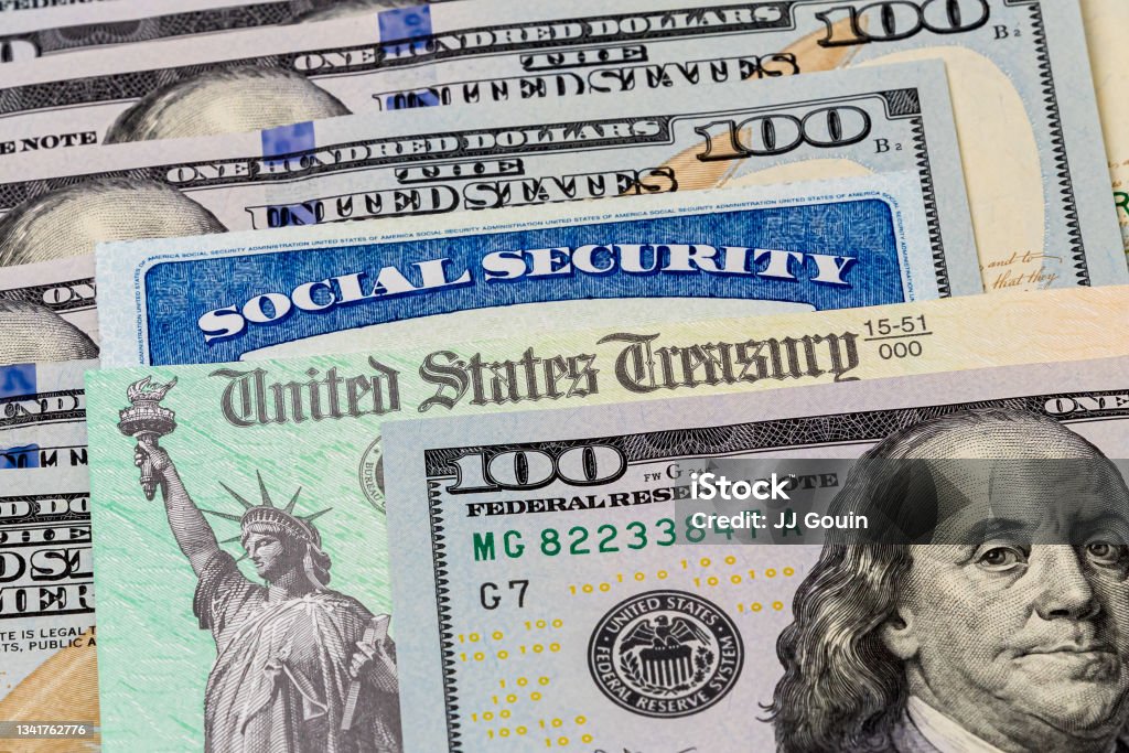 Social Security card, treasury check and 100 dollar bills. Concept of social security benefits payment, retirement and federal government benefits background, no people Social Security Stock Photo