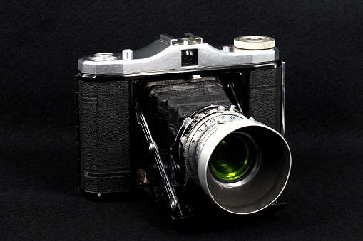 Front view of a German made vintage Zeiss Ikon Nettar bellows or folding type medium format camera with the lens extended. The camera uses 120 mm roll film.