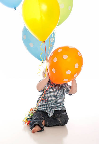 Little boy playing with balloons stock photo