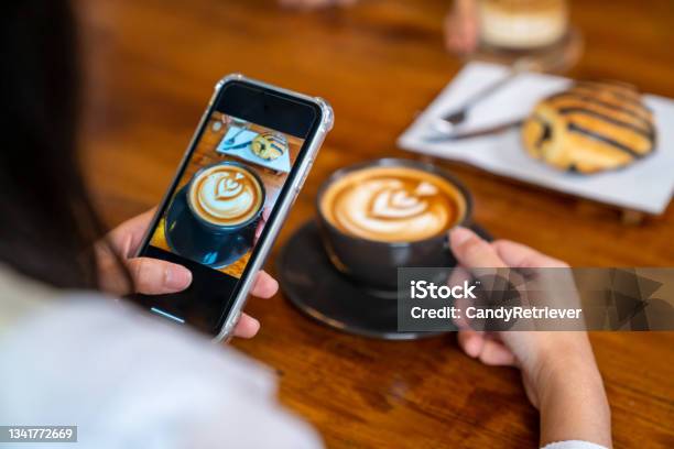 Asian Woman Using Smartphone Photography Coffee Latte And Dessert On The Table At Coffee Shop Stock Photo - Download Image Now