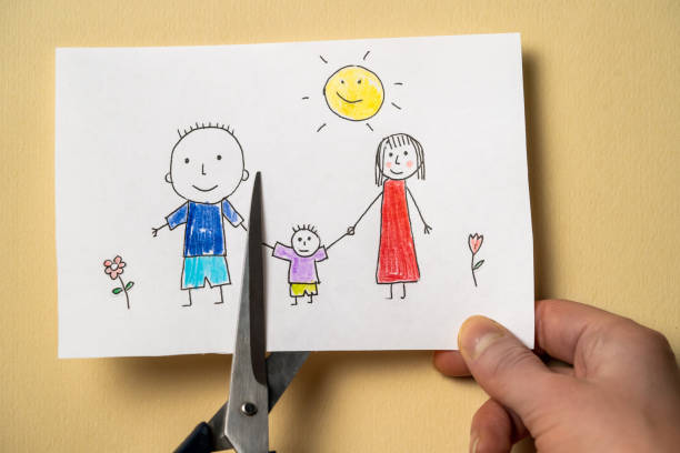 istock Child's drawing, which depicts mom, dad and child, is cut with scissors. 1341774003