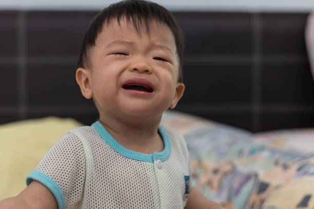istock A baby with with unhappy mode and crying 1341776333