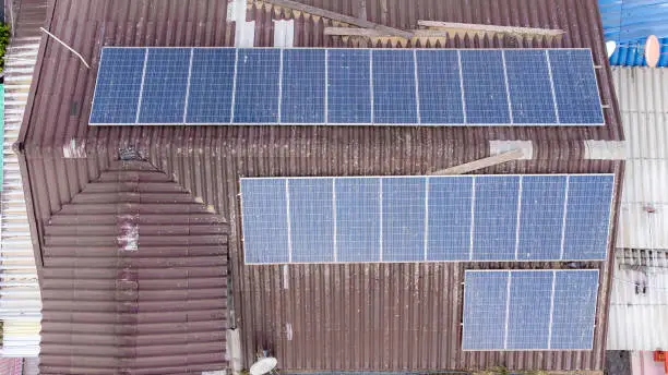 Old Solar panels on houseroof from aerial view.