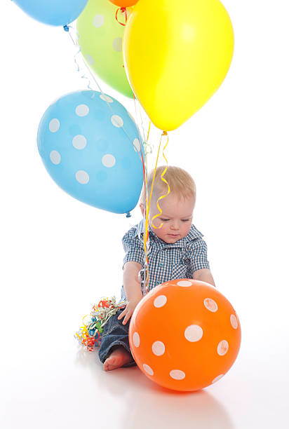 Little boy playing with balloons stock photo