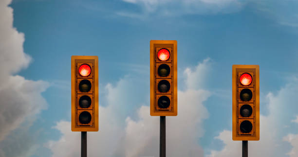 istock 3 Traffic lights against blue sky 1341778825