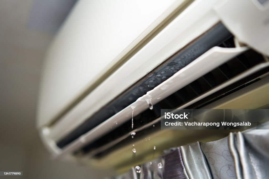 Water leaking from the air conditioner drips from the cooler. Water leaking from the air conditioner drips from the cooler.  Air Conditioner Stock Photo