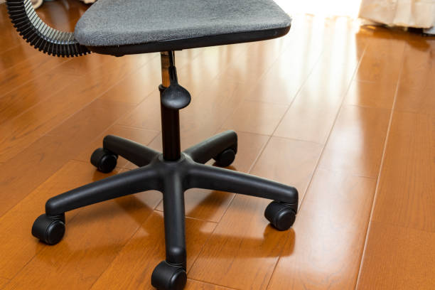 istock Black chair with casters on a wooden floor 1341781172