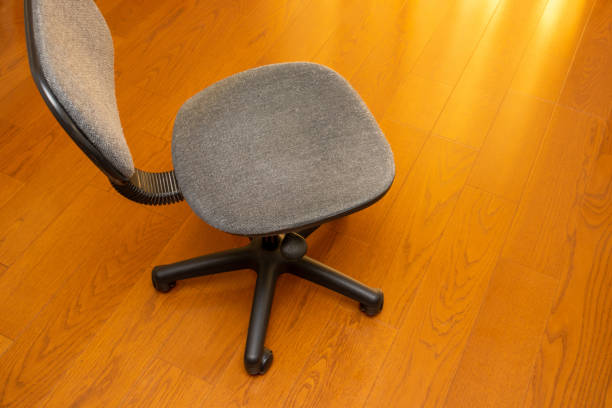 istock Black chair with casters on a wooden floor 1341781173