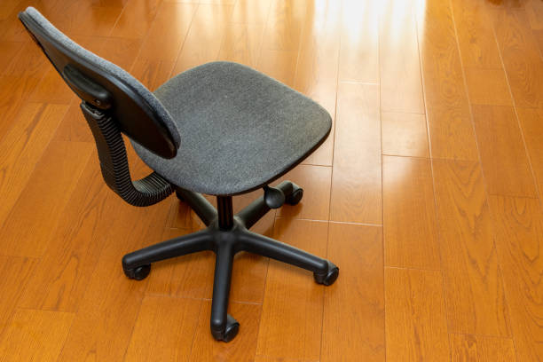 istock Black chair with casters on a wooden floor 1341781180