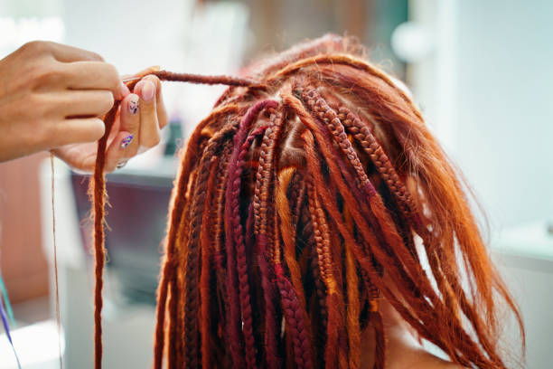 istock Close up of braiding process african plaits with colored kanekalon. 1341781437