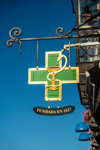 Leon, Spain - August 16, 2021:  Sign for the Farmacia Alonso Nuñezin in Leon, Spain which dates back to 1827 and is tourist attraction for its beautiful interior.