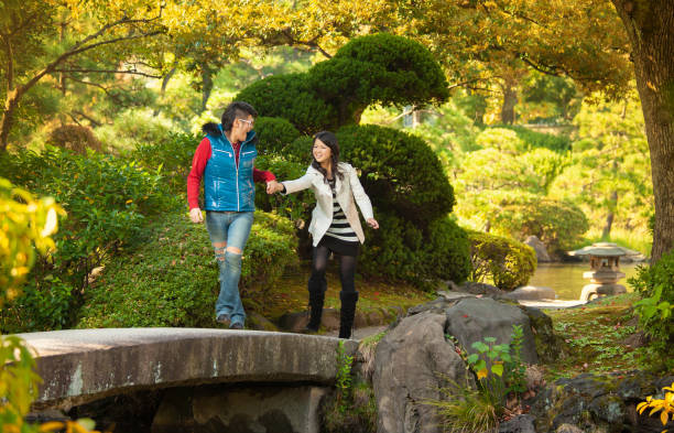 istock Young couple spending the afternoon walking around a park 1341784960