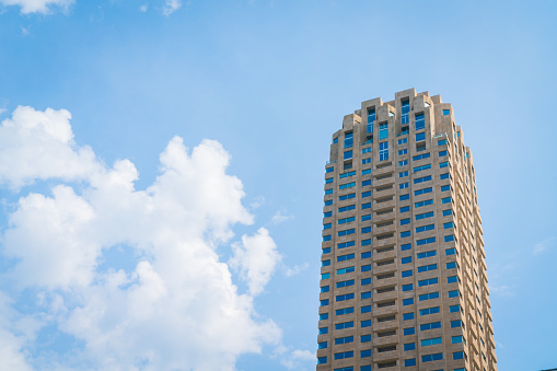 Rotterdam Netherlands -  24, 2017;   Tall ZH apartment building rising into blue sky with it's  repeating patterns of windows and balconies..