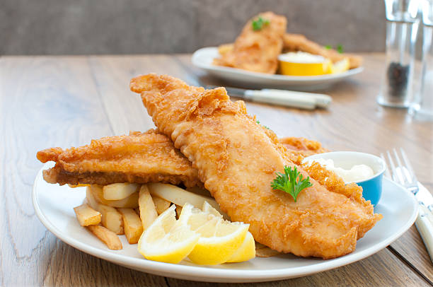 fish and chips - cod fillet fried prepared fish stock-fotos und bilder