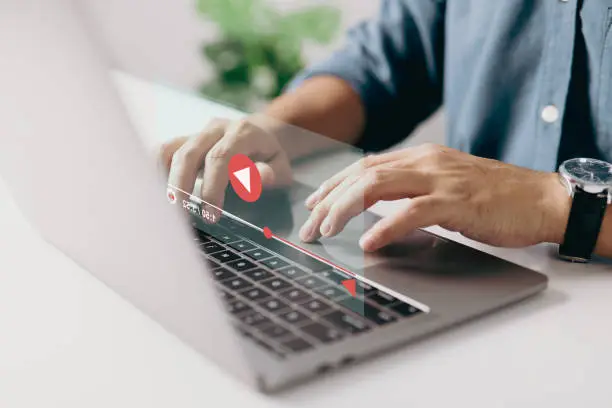 Man hands using laptop for streaming online, watching video on internet, show or tutorial, live concert