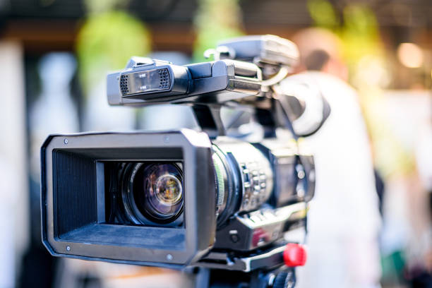 istock Professional cameraman working with digital video camera for live streaming event 1341792808