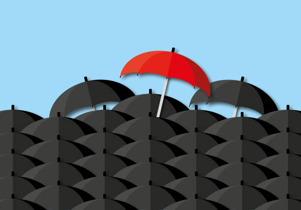 istock Red umbrella glowing light stand out among other black umbrella on pastel blue background. 1341794666