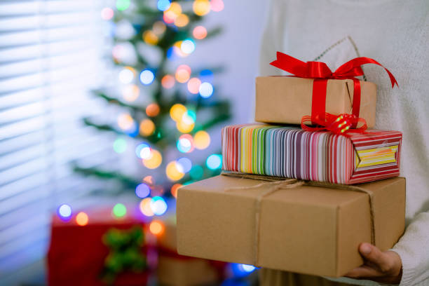 istock Young woman wrapping a gift box. 1341794703