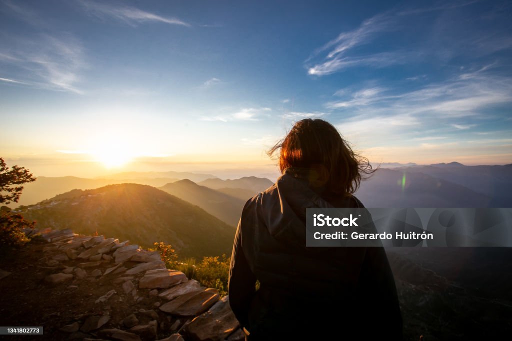 Woman enjoying the view Woman enjoying the view of sunrise in the mountains. Horizon Stock Photo