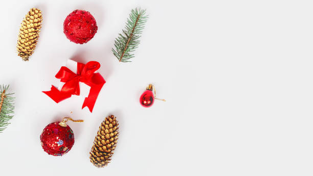 istock Christmas background with red Christmas decorations on a white background with a Christmas tree. Merry Christmas greeting card, banner. Winter holidays theme. Happy new year concept. space for text 1341804438