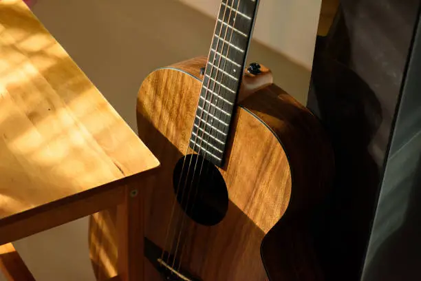 Acoustic guitar close-up on a beautiful colored background, the concept of stringed instruments