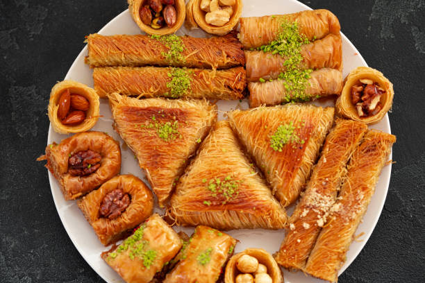 istock Delicious baklava dessert in oriental setting on black background 1341806734