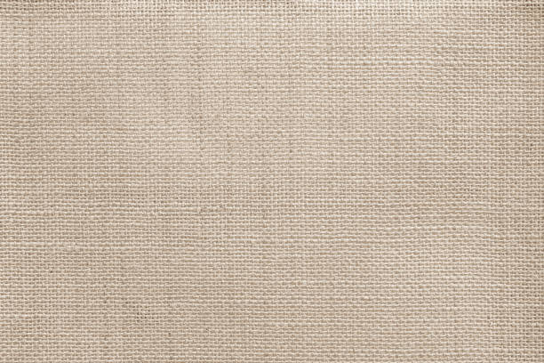 istock Jute hessian sackcloth canvas woven texture pattern background in light beige cream brown color blank empty 1341808196