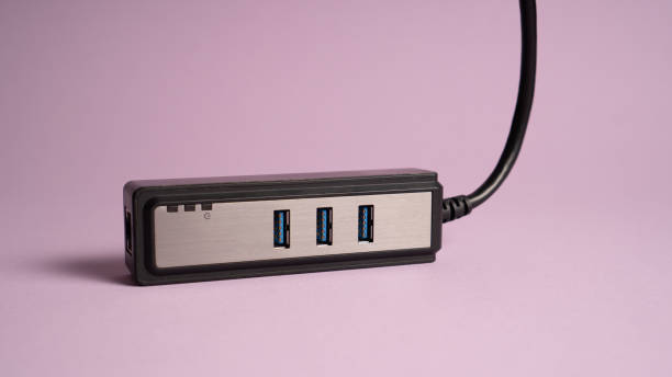 istock Black USB hub isolated on violet. Three ports USB charger 1341809002