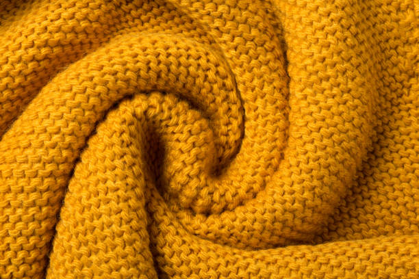 istock yellow knitted fabric twisted like a snail shell textured background 1341809205