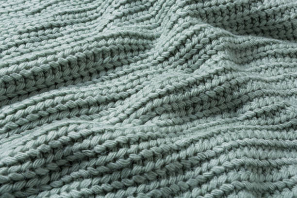 istock chunky knit, pastel blue-green, lined with folds, selective focus 1341809215