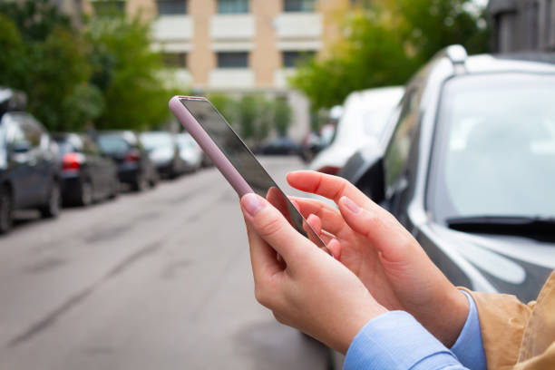 istock Woman holding mobile phone and booking cab. 1341809318