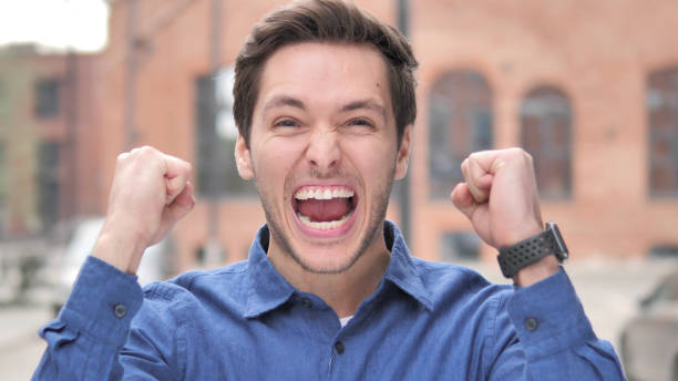 istock Young Man Celebrating Success  Gesture in Office 1341810611