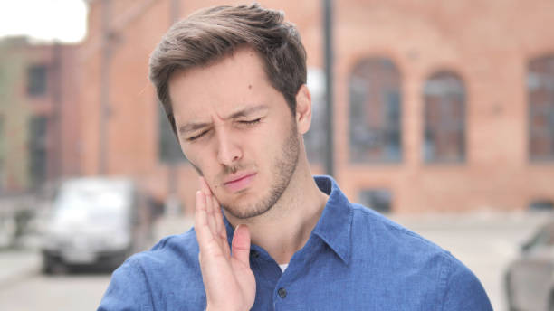 istock Toothache, Young Man with Tooth Infection 1341811249