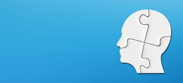 istock Head made of white jigsaw puzzle four pieces with copy space on blue background 1341811325