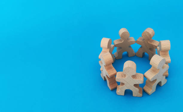 Teamwork and cooperation concept, people stand in a circle on a blue background
