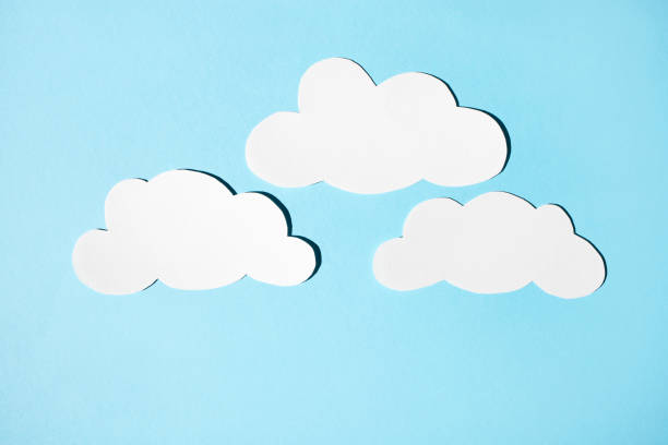 istock Clouds of white paper on a blue background. Flat lay, place for text. 1341811592