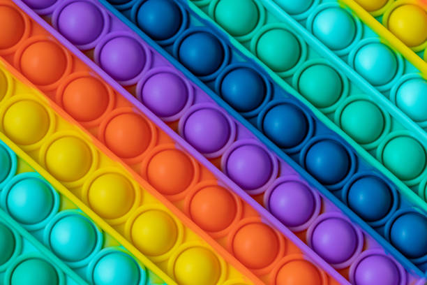 istock Rainbow Fidget Toys Pop it background and texture. Push Pop Bubble toy for kids. 1341811776