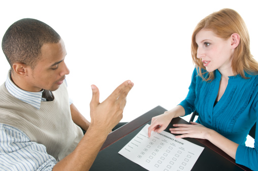 Manager going over poor performance review with employee.
