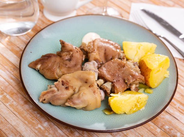 Pig's trotter served on white plate Pig's trotter served on white circular plate with potato. hedgehog mushroom stock pictures, royalty-free photos & images