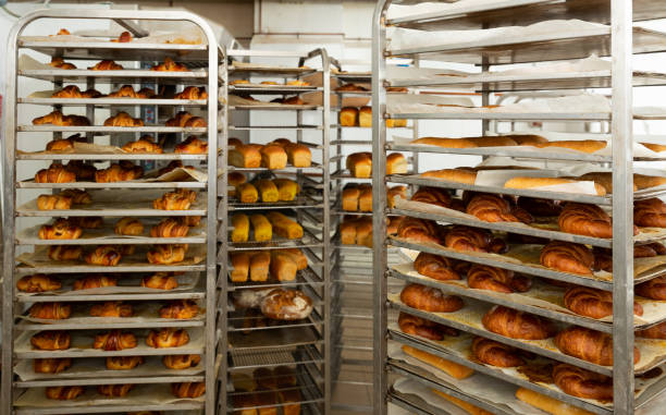 istock Trolley with baked bread in bakery 1341814301