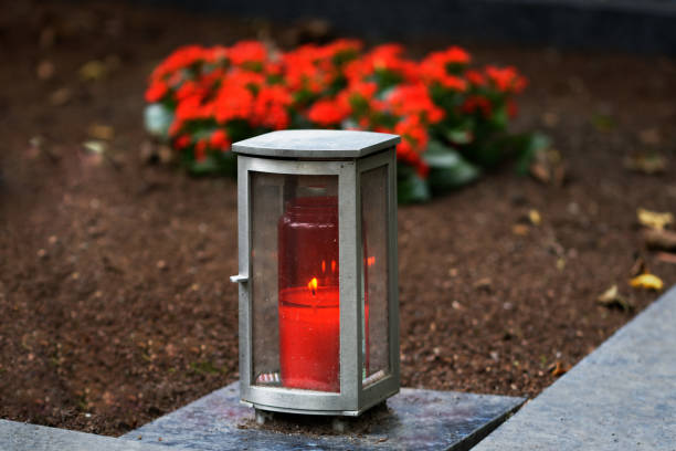 istock metal grave lamp with burning candle 1341816278