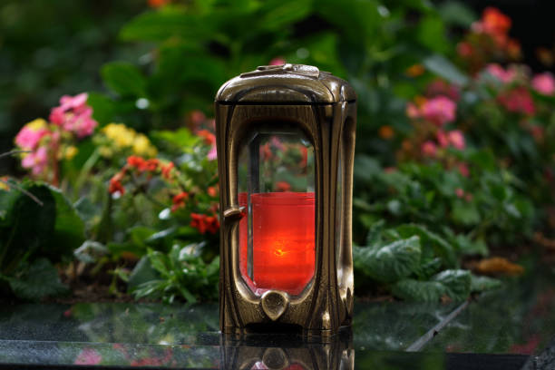 istock metal grave lamp with burning candle 1341816282