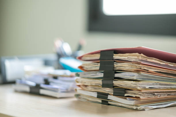 istock Stack of documents with paper clip folder placed on a business desk in a business office. 1341817979